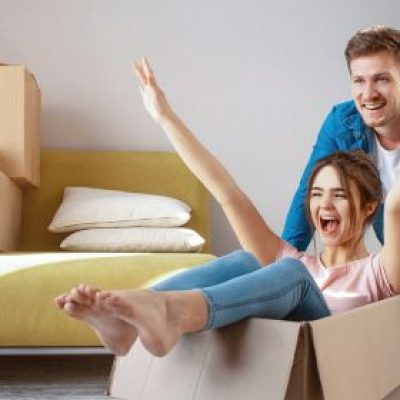 A young couple messes around with used boxes after moving into their new home.
