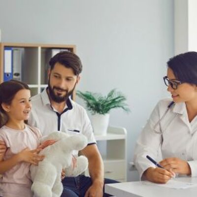 A young family taking their daughter to the doctor for a check up.