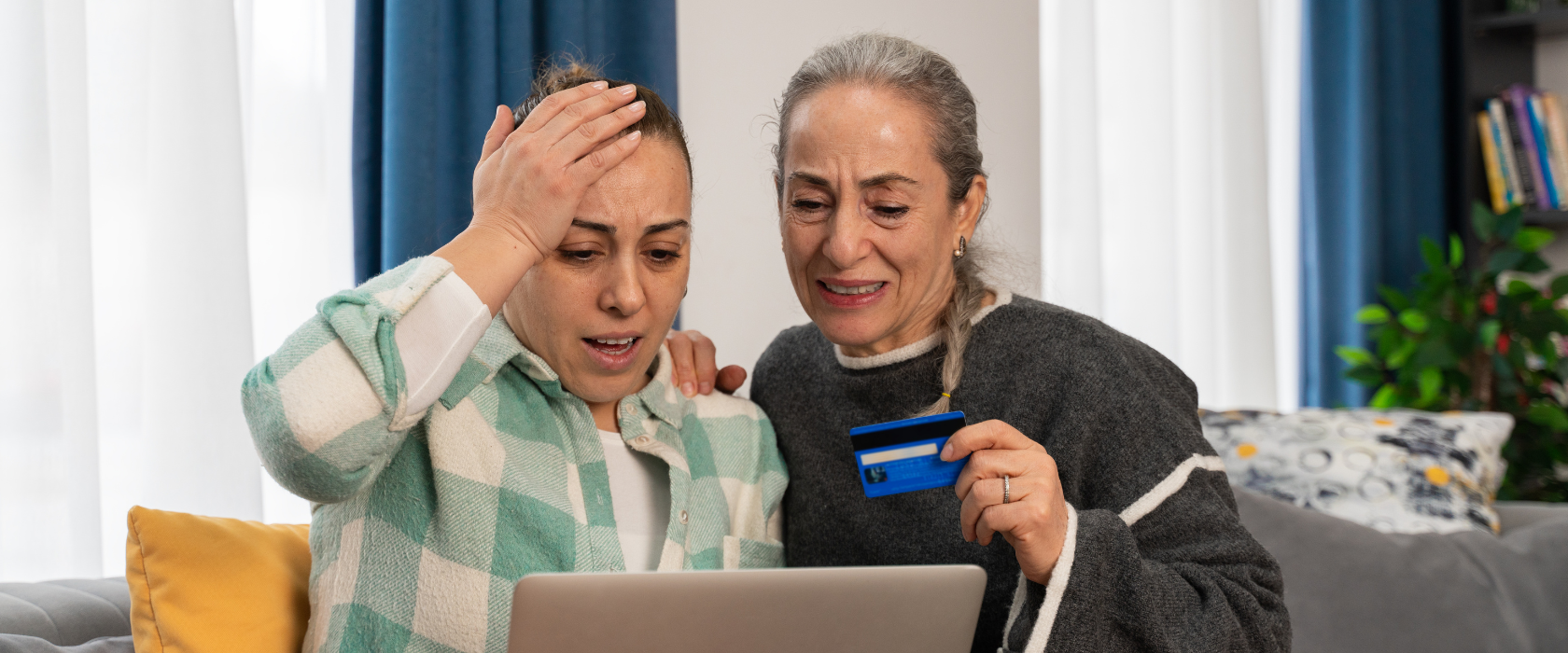 two women look at their screen with disgust after entering financial information.