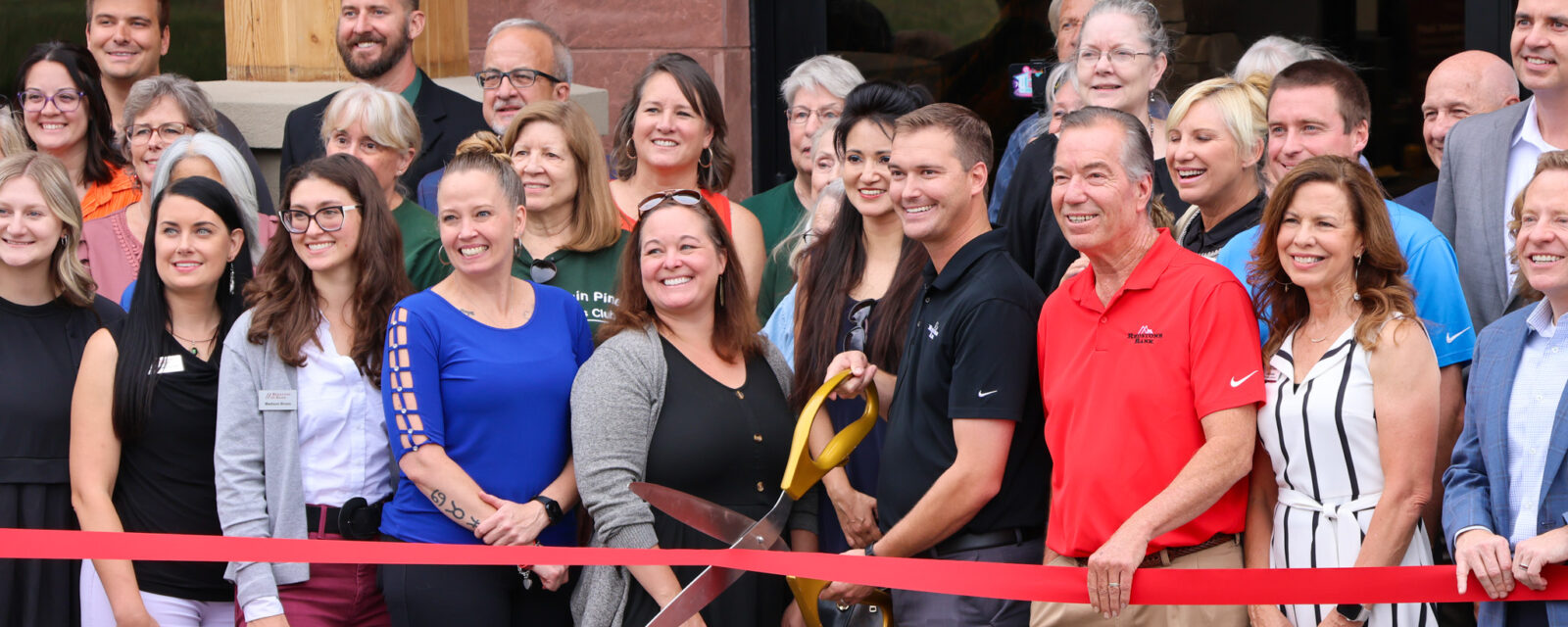 Parker Ribbon Cutting staff and guests outside the new building