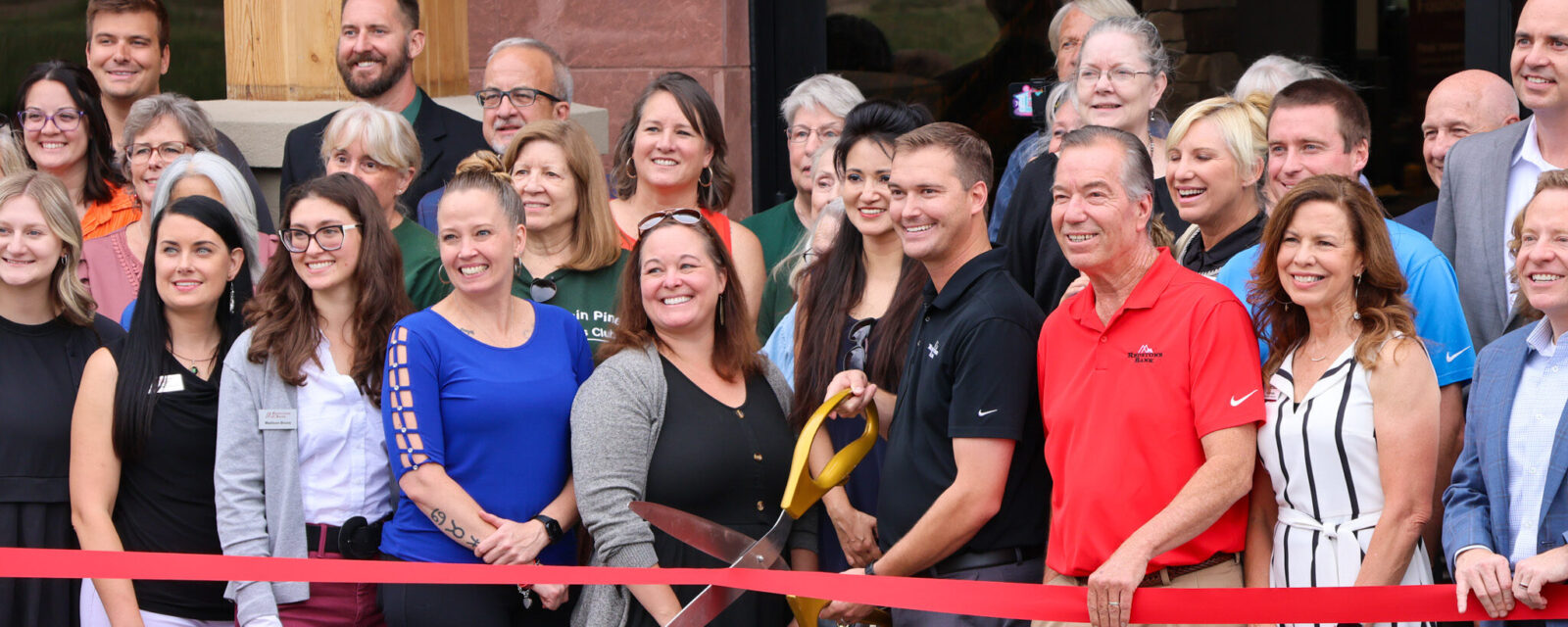 Parker Ribbon Cutting staff and guests outside the new building