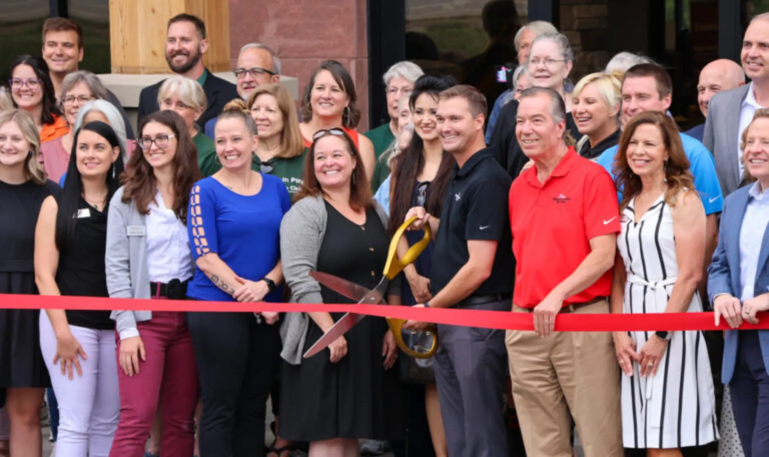 Parker Ribbon Cutting staff and guests outside the new building