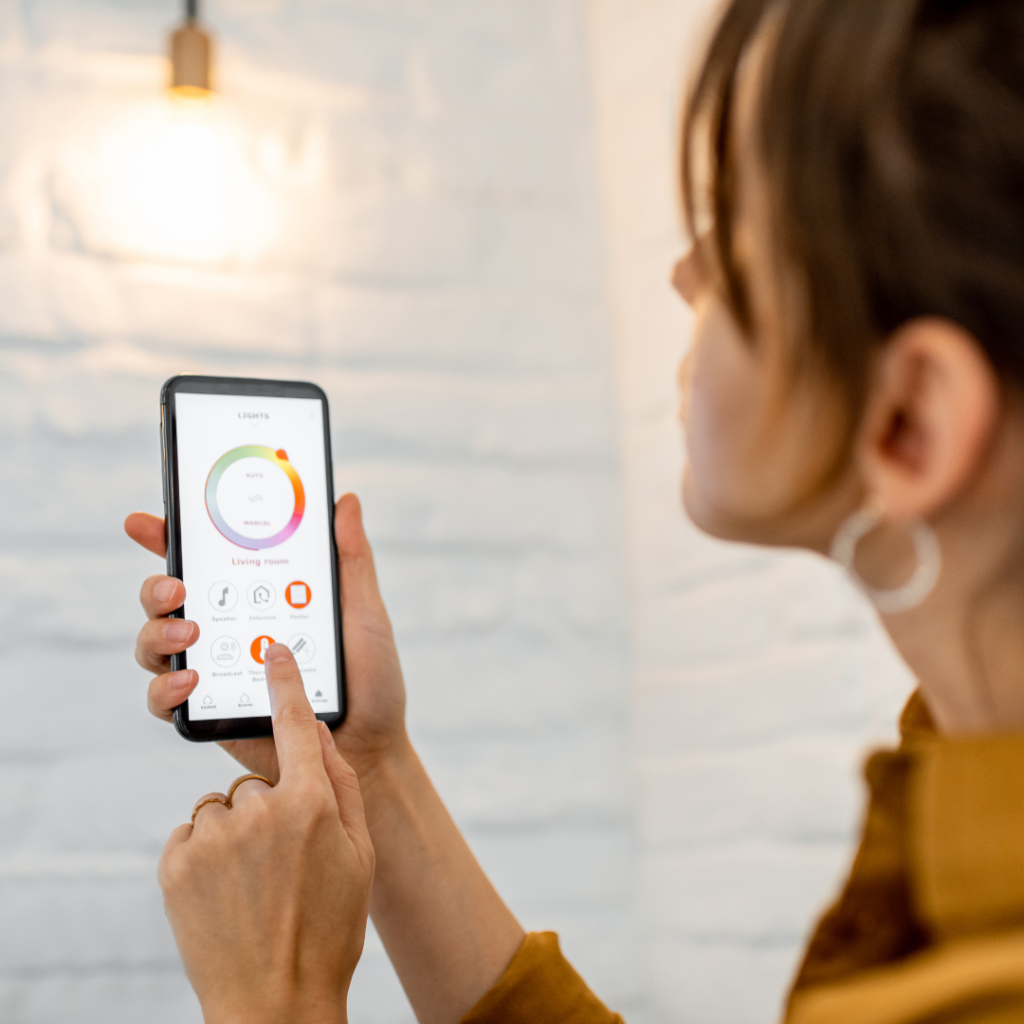 A woman controlling her smart lighting with her phone