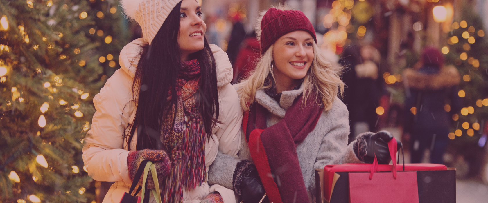 Two women shopping at Christmas time holding shopping bags