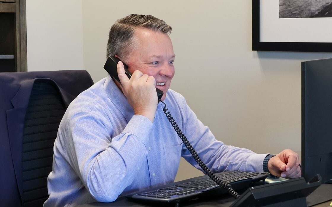 Heath Kinsland, Market President at Littleton talks to a client on the phone about an IRA