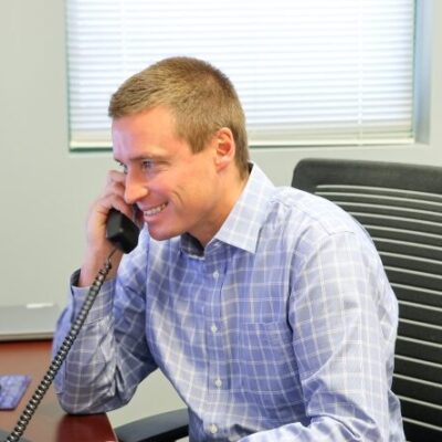 Dillon Joslyn, Business Development officer talking on the phone to a client at the Parker branch.