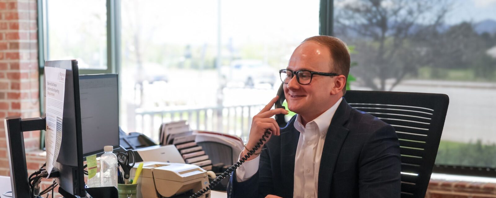 Kevin Knox, Personal Banker at the Littleton branch on the phone with a client.