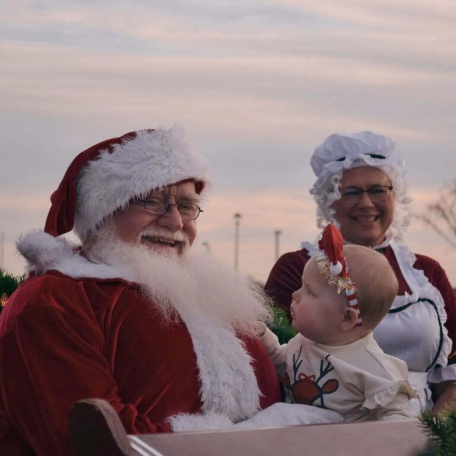 Santa and Mrs. Claus with a baby
